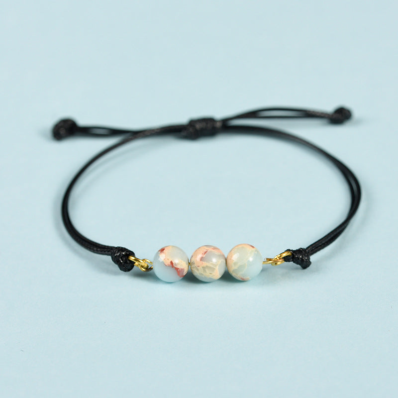 Hot-selling simple black rope Sansheng III bracelet pink crystal tiger eye stone spring design transfer bead bracelet